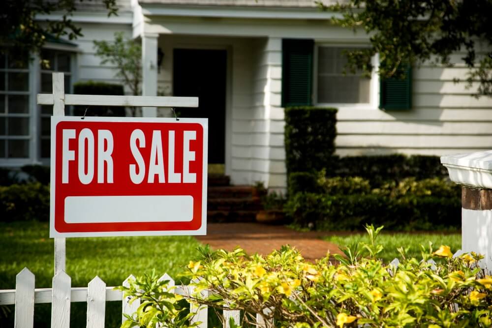 For sale sign outside a family house