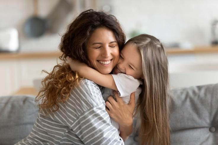 A mother hugging her daughter